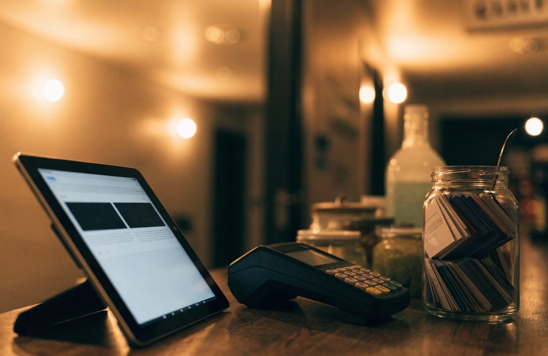A small shop counter with a tablet showing a simple website